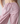 Pink and white vertically striped lounge pants with an elastic drawstring waist, shown on a model.