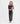 A woman modeling a sheer, long-sleeved maxi dress with a dark leopard print pattern, standing against a plain white studio background.