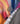 Close-up of a colorful fabric with a metallic emblem on a colorful swimsuit
