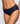 A close-up of a model wearing a pair of dark navy blue full brief panties with a subtle textured pattern, shown against a light gray background.